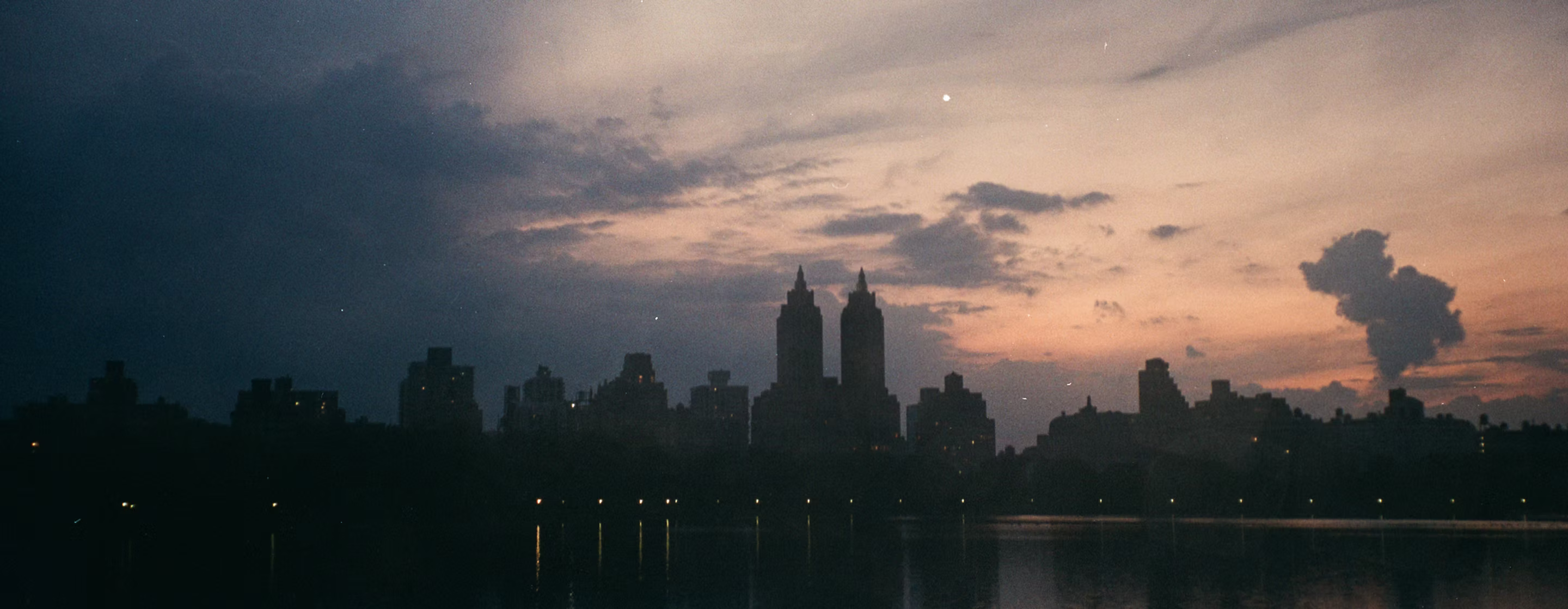 A vintage, grain-textured view of the New York City skyline at dusk.